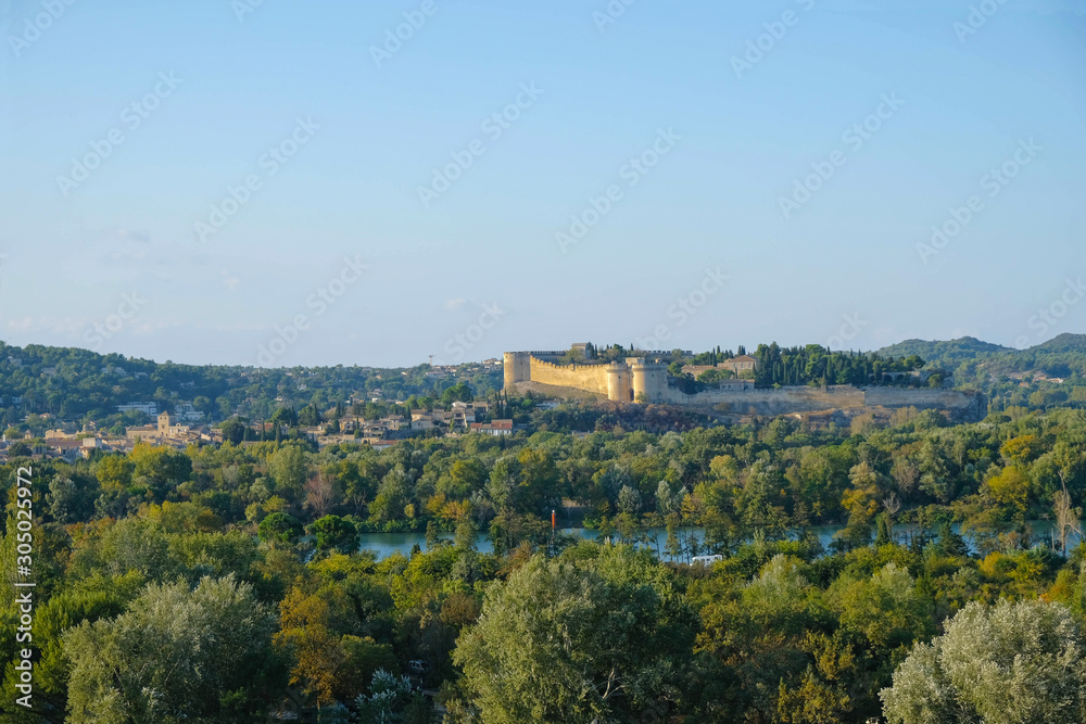Old fortress on a hill over the river Rhone at golden hour in Avignon. Provence tourism.
