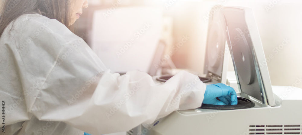 Εκτύπωση καμβά Laboratory technician using centrifuge device automation machine for testing and diagnostic clinical specimens sample in lab room of hospital