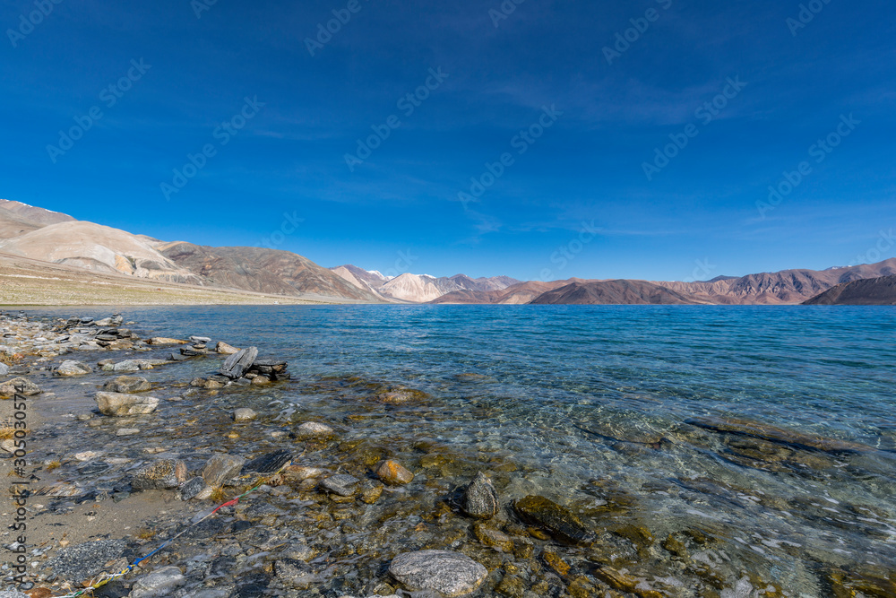 Stone stacked on the bank of  Pangong Lake or Pangong Tso in Ladakh, India 