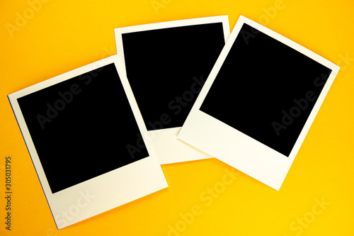 Three photos with the image of a black square lie on a yellow background.