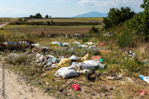 Littering in Nature with fields and mountin in background.
