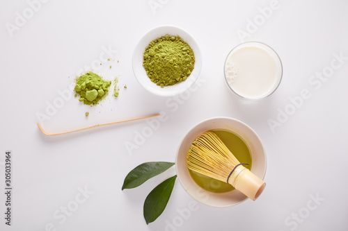  Matcha green tea powder view from above, traditional matcha tea preparing , white background. Flat lay 