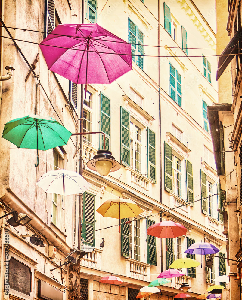 Genova, Italy old town: multicolored umbrellas hanging over the street  as decoration for an event