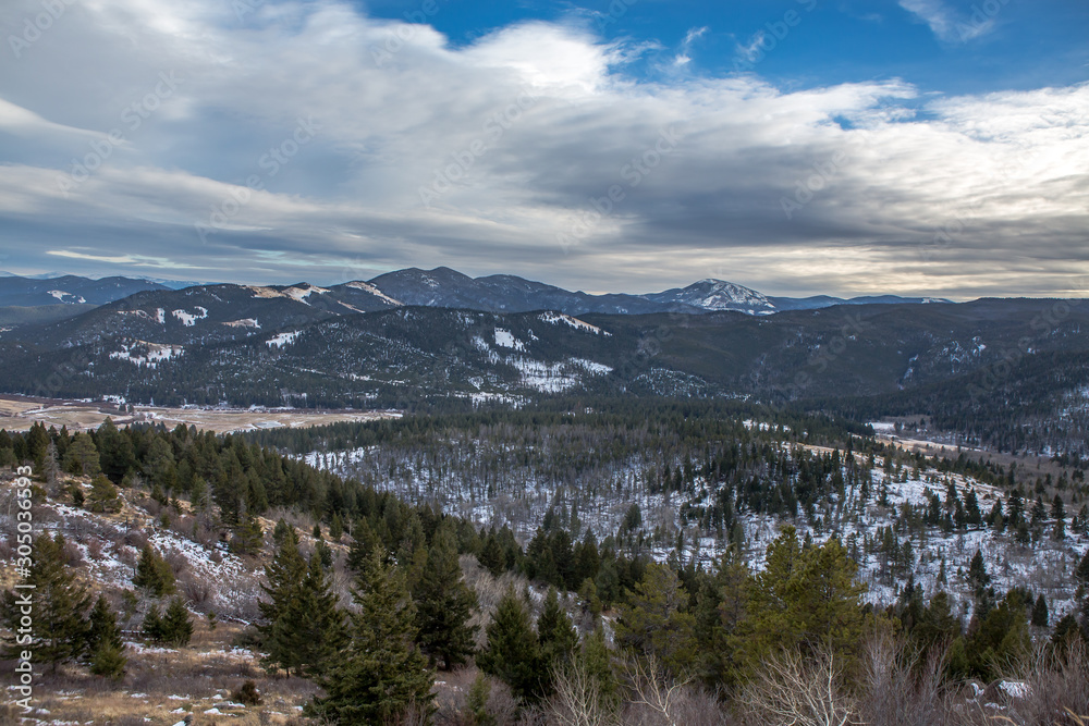 Expansive snow covered valleys in a mountain range. Beautiful background.