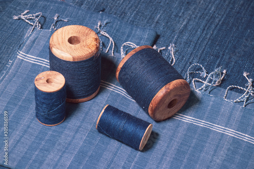 Indigo dyed yarn in reel and indigo dyed woven fabric background photo