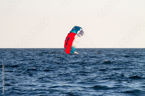 paragliding in the sky over the blue sea © VIKTOR