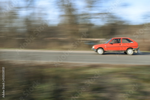 A red car is racing.