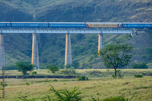 Pune, India - November 03 2019: Passenger train crossing a viaduct at Shindawane near Pune India.