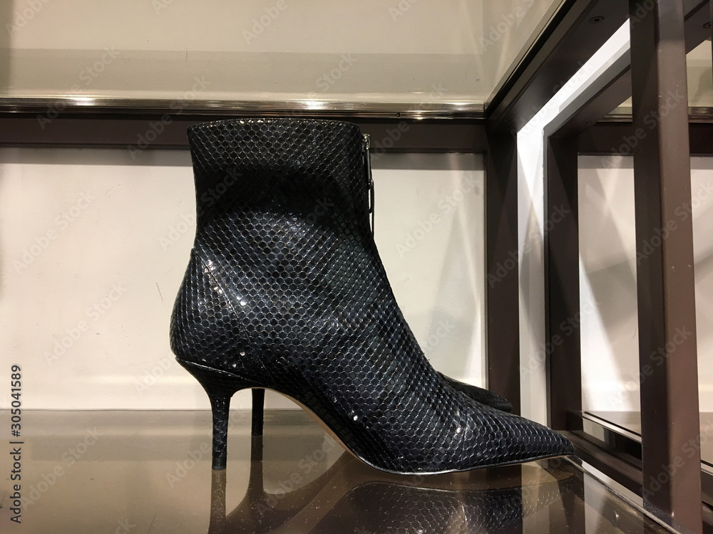 Black mid-heel ankle boots with animal print on the shelf. Demonstration of  fashionable women's shoes. Mass market shop. Sale of modern women's shoes.  Ladies High Heel Boots Stock Photo | Adobe Stock