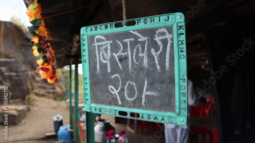 Pune, Maharastra/India- November 18 2019: Chalk and black board slate. Bisleri water bottle for sale in a shop.