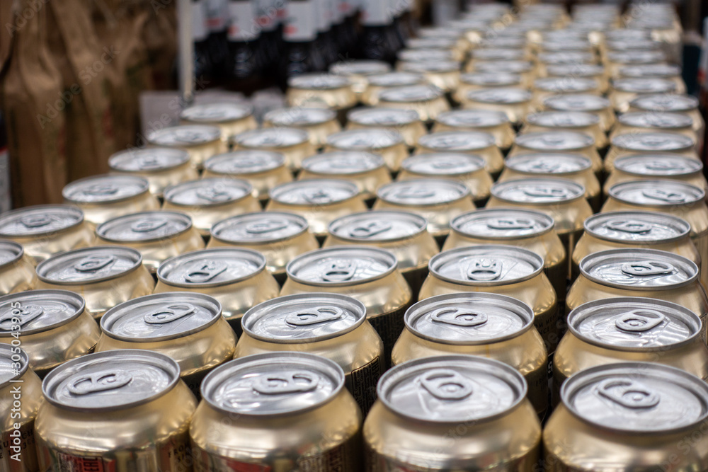 Many metal cans with cool drinks. A group of objects. Many metal cans with cool drinks. A group of objects.