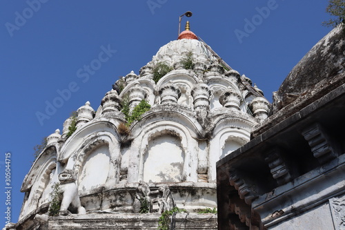 Skewed view of temple top. White colored decorated dome of an ancient pagoda. photo