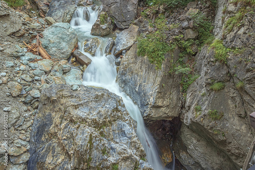 Debris and broken trees in a waterfall in the Kitzlochklamm, a deep gorge near Zell am See photo