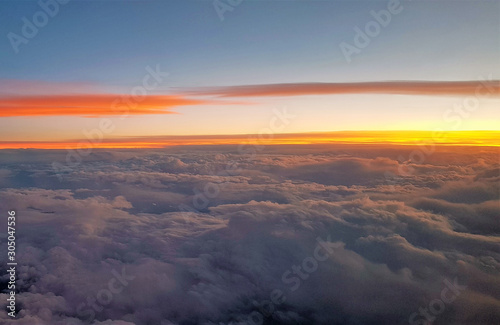 flying above the clouds in the evening