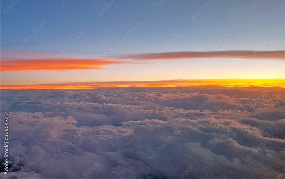 flying above the clouds in the evening flying above the clouds in the evening