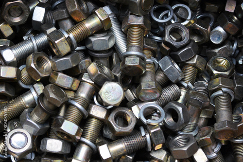 Сlose up of bright and shiny nuts, bolts and washers. Industrial background.