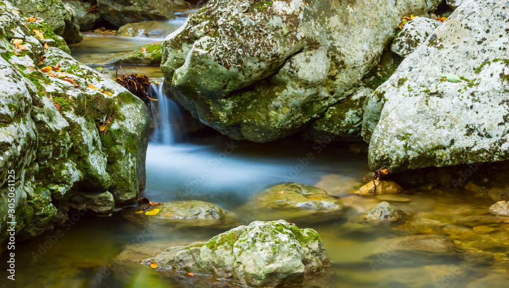 Obraz premium closeup small waterfall on a mountain river