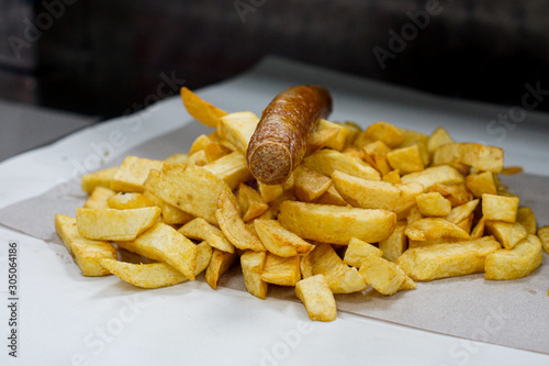 Fish and chip shop, Chips on paper ready to be servered photo