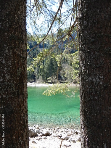 Lago di Tovel con riflessi di Dolomiti con la neve acqua verde e limpida photo