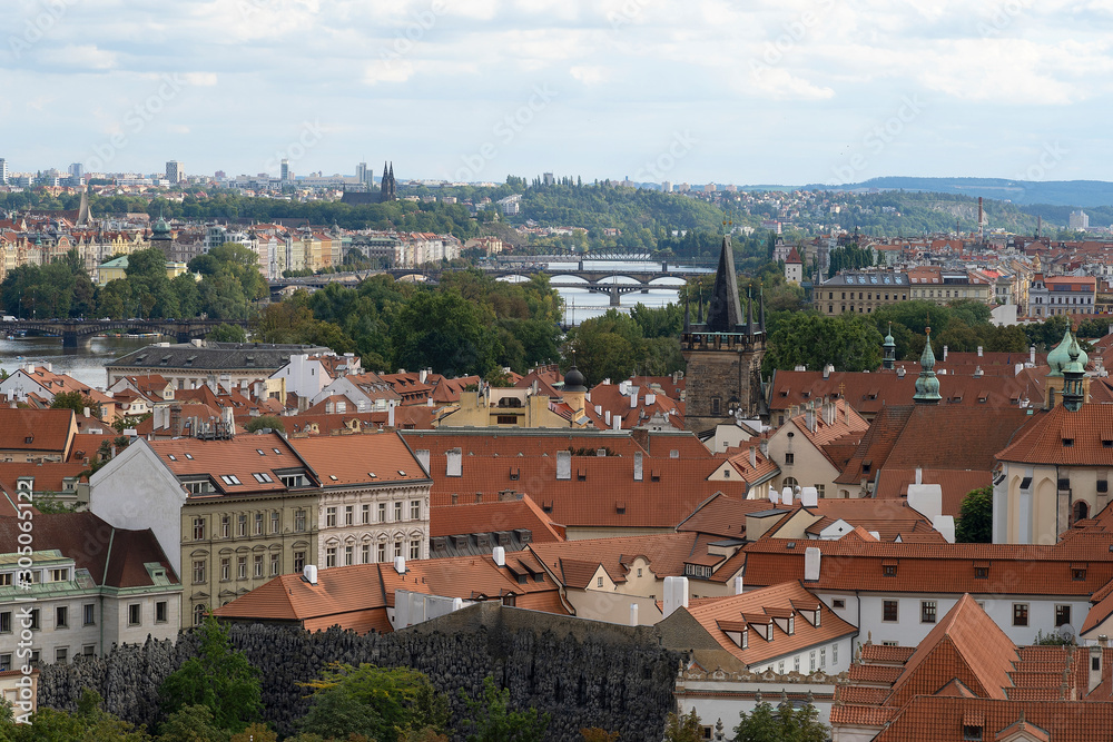 Red terracotta roofs in the city of Prague. View of the city from above, in the distance the tower, sunny day. A beautiful city for leisure and travel in Europe. Red terracotta roofs in the city of Prague. View of the city from above, in the distance the tower, sunny day. A beautiful city for leisure and travel in Europe.