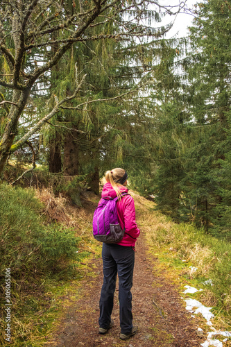 Girl on the the path in woods in National Park of the Czech Bohemian forests, Czech Republic. 