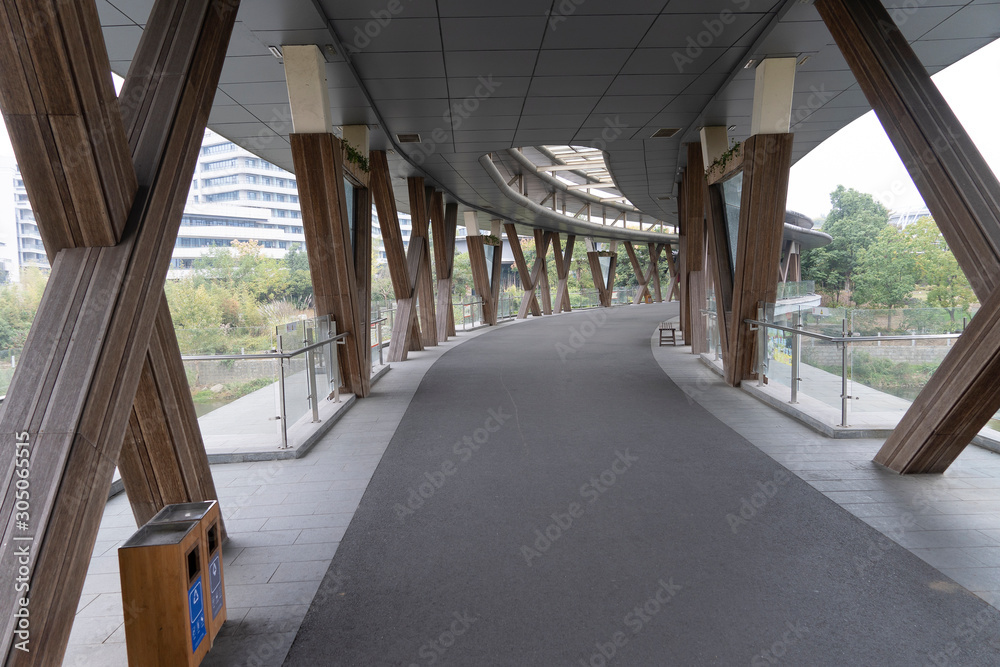Road bridge across the river covered with asphalt. Ecological wooden poles and a modern roof for protection against rain. Pedestrian walkway with a metal. Road bridge across the river covered with asphalt. Ecological wooden poles and a modern roof for protection against rain. Pedestrian walkway with a metal.