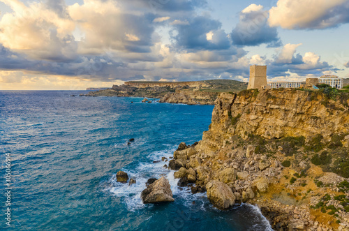 Ghajn Tuffieha Tower. Aerial view from the sea, sunset, cloudy sky. Landscape. Malta country