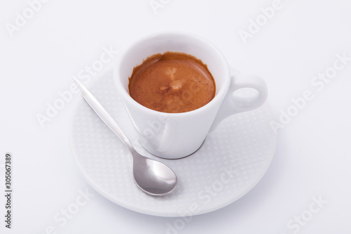 A white cup of coffee with spoon on white background