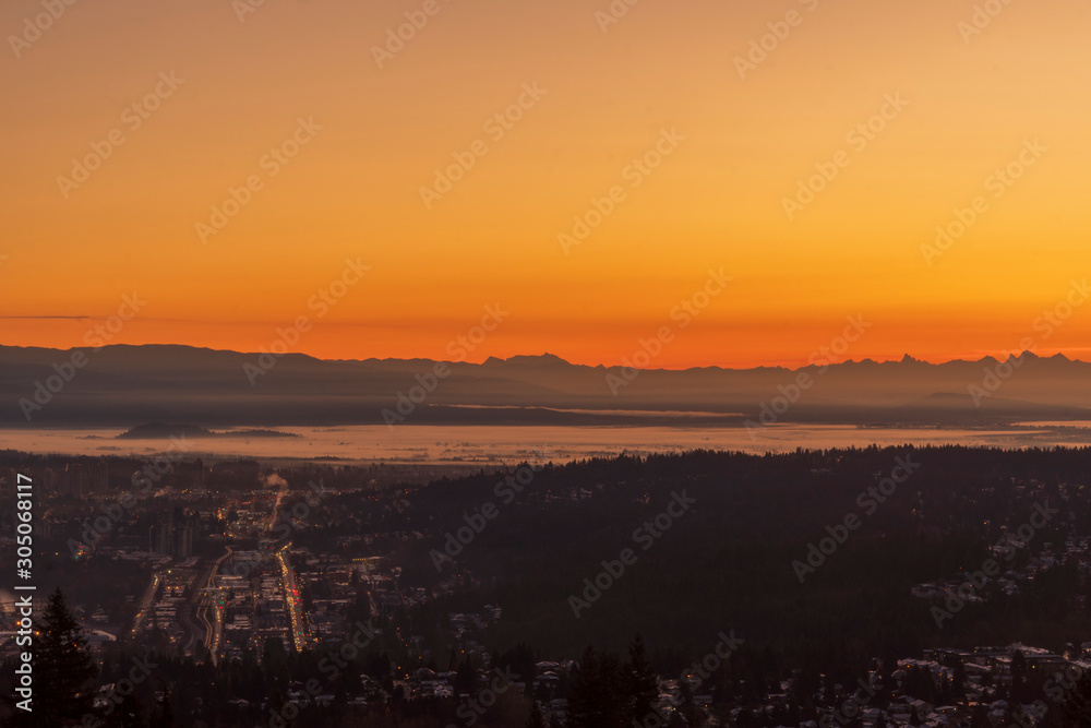 Orange glow of sunrise over Fraser Valley inversion - viewed from Burnaby Mountain