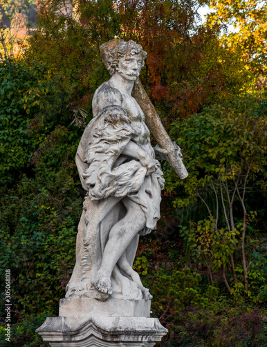 Old statue and colorful autumn colors in the park