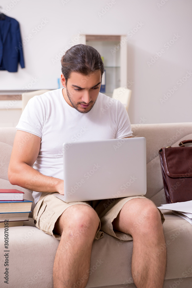 Young male student preparing for exams at home Young male student preparing for exams at home