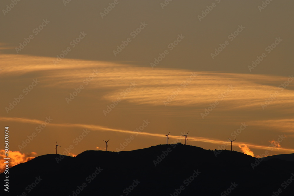 Wind turbines in Mediterranean mountains at sunset, renewable Energy, solar  power, concept clean energy, future of energy production