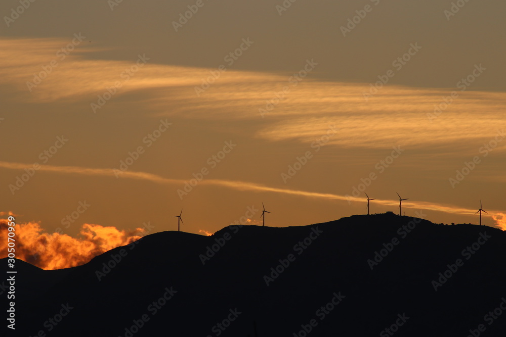 Wind turbines in Mediterranean mountains at sunset, renewable Energy, solar  power, concept clean energy, future of energy production