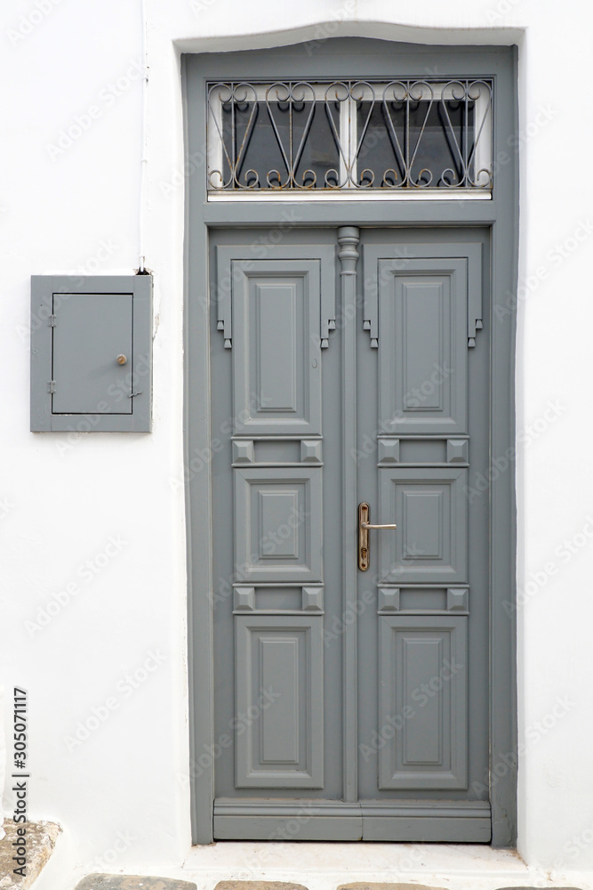 one of the charms of Mykonos, Greek Cycladic island in the heart of the Aegean Sea, are the beautiful colored doors of the houses of the narrow streets of the ancient city one of the charms of Mykonos, Greek Cycladic island in the heart of the Aegean Sea, are the beautiful colored doors of the houses of the narrow streets of the ancient city