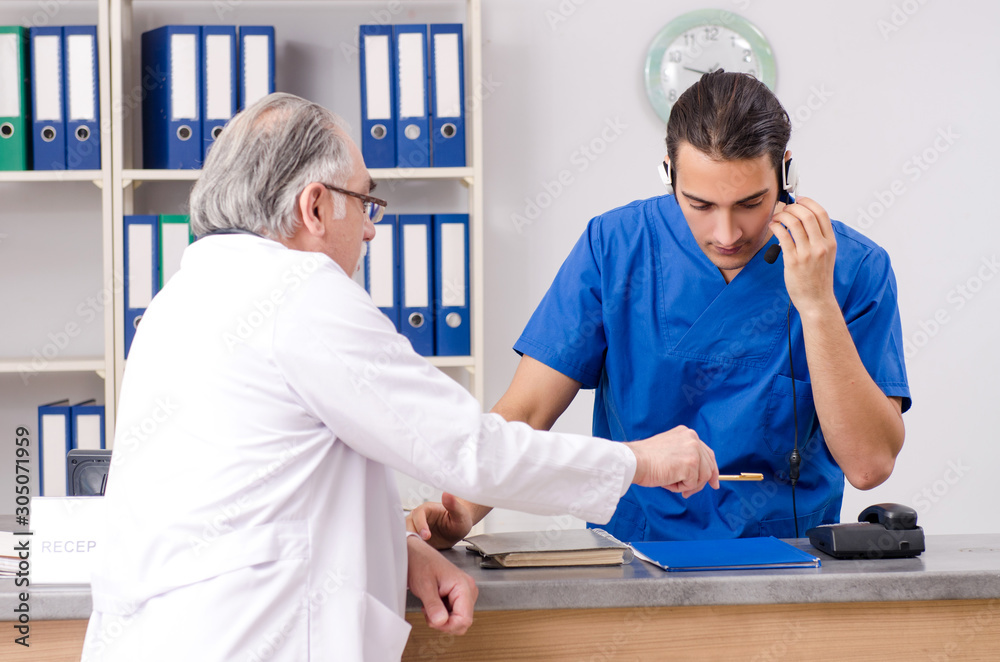 Fototapeta premium Two doctors talking at the reception in hospital