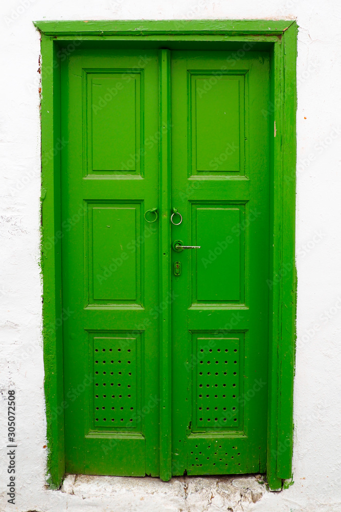 one of the charms of Mykonos, Greek Cycladic island in the heart of the Aegean Sea, are the beautiful colored doors of the houses of the narrow streets of the ancient city