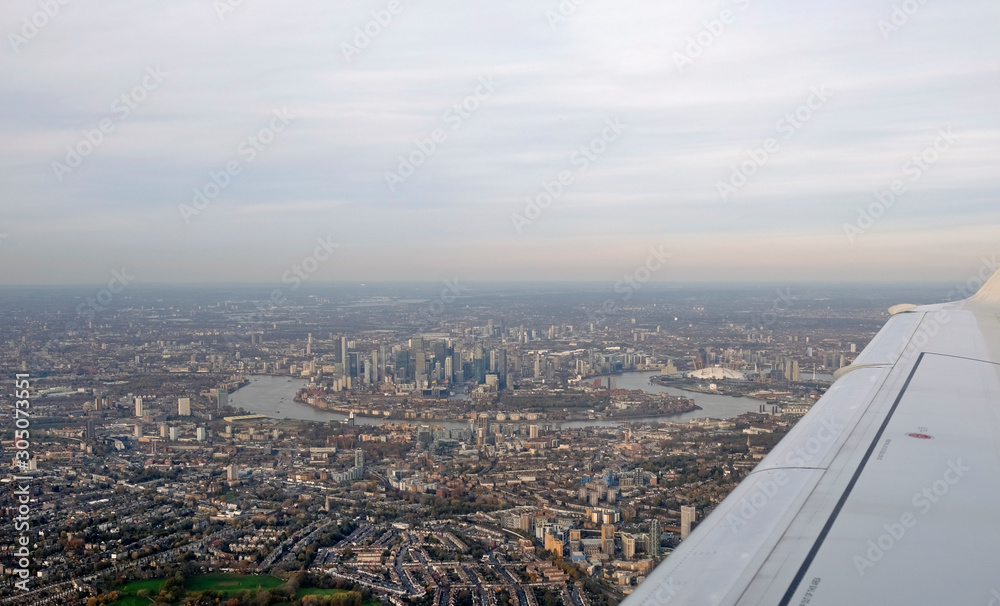 The skyline of London seen from the window seat of a plane
