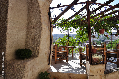 Natural rock formations and grapevine terrace and city in Cappadocia near Goreme, Turkey.
