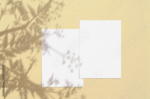 Blank white vertical paper sheet 5x7 inches with shadow overlay. Modern and stylish greeting card or wedding invitation mock up.