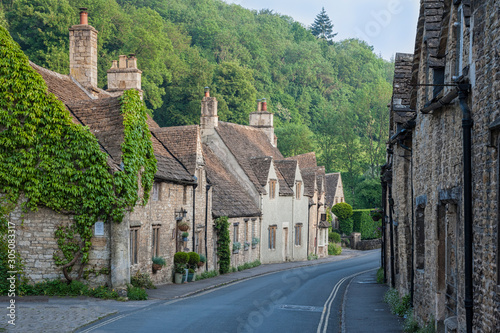 CASTLE COMBE, COTSWOLDS, UK - MAY 26, 2018: Typical and picturesque English countryside cottages in Castle Combe Village, Cotswolds, Wiltshire, England - UK