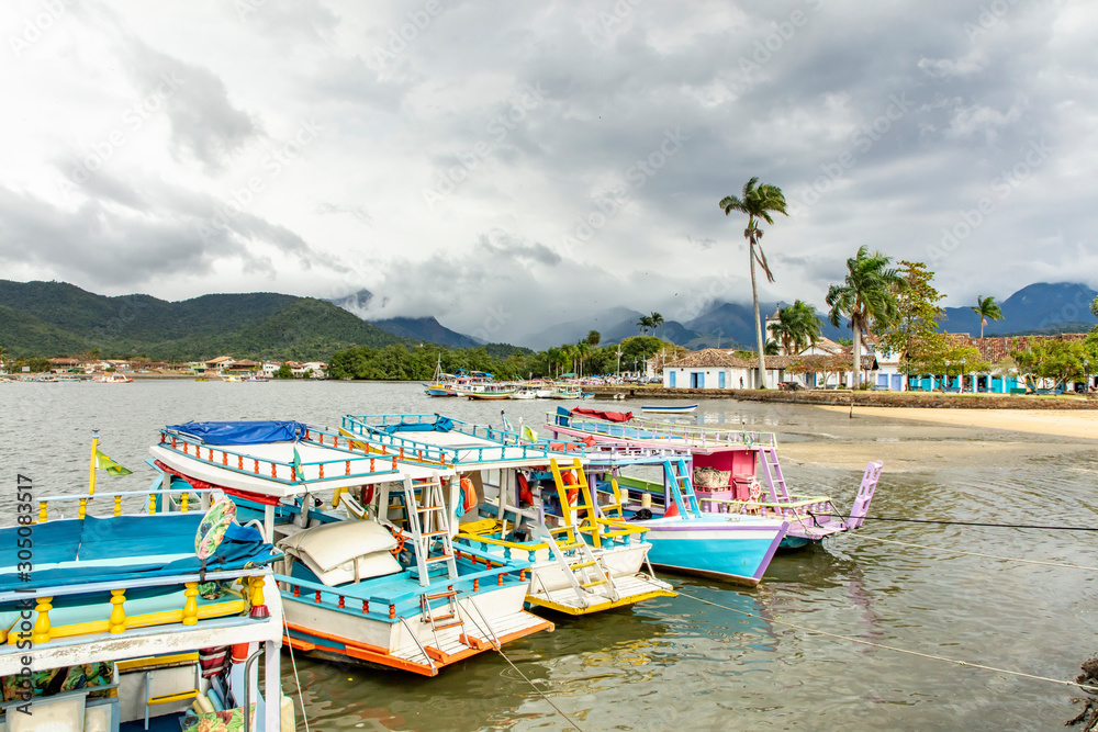 Tourist boat dock in Paraty Bay in Rio de Janeiro, Brazil, where passenger boats await customers to be taken to nearby islands or other villages. world heritage