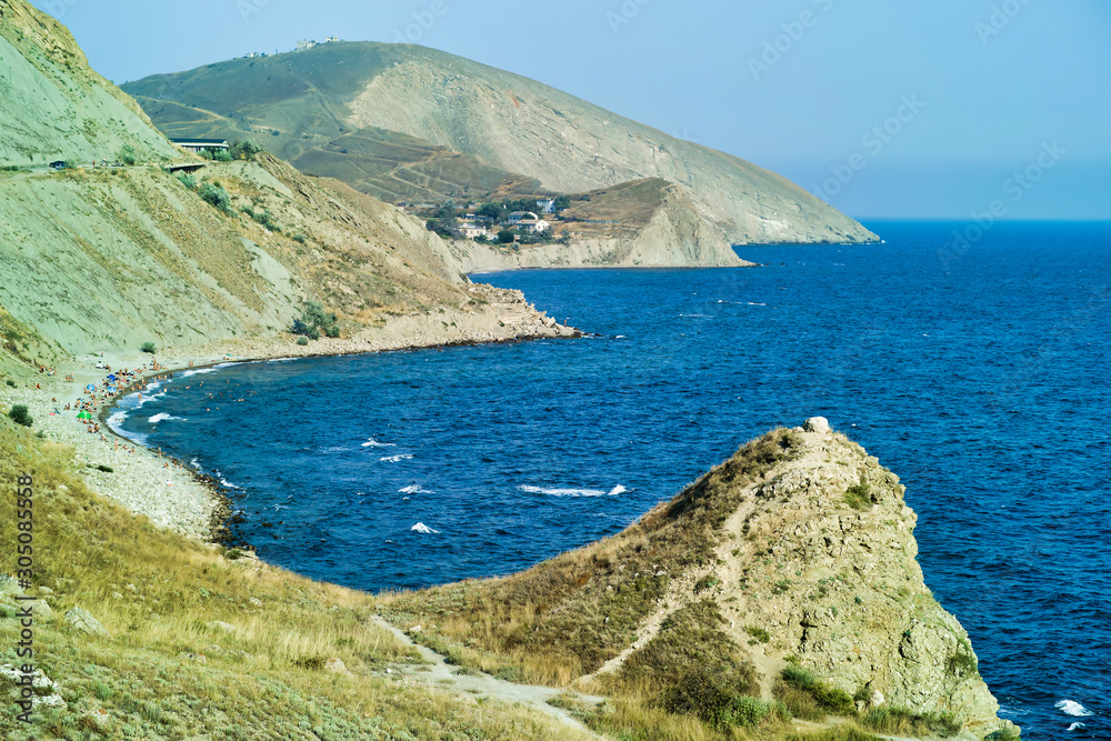Cape Black sea in the village of Ordzhonikidze in the Crimea, in the summer with a textured sky with clouds. And hilly terrain, landscape