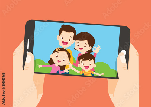 hand hold smartphone with the family take photo