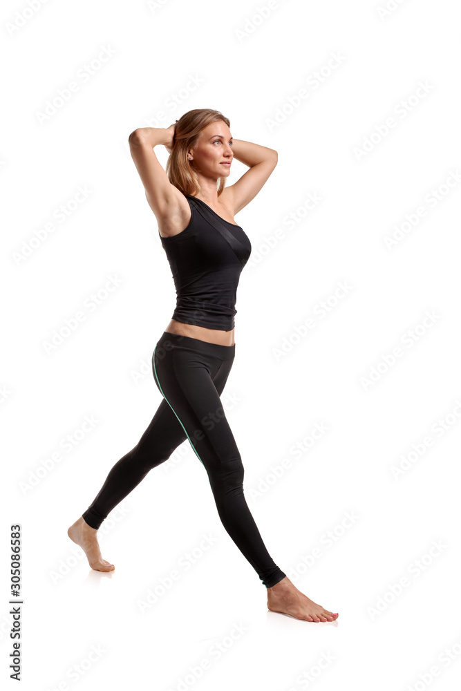Young beautiful fitness woman posing on white background Young beautiful fitness woman posing on white background