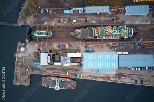 Dry dock and ship with shipbuilding in construction activity aerial view from above Greenock UK photo