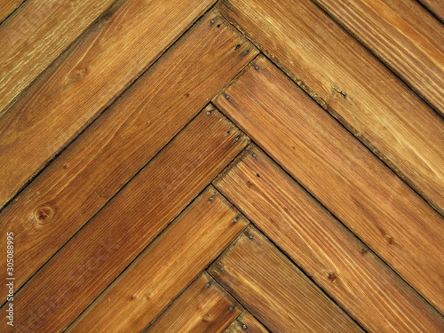 Wood plank background. Texture of wooden planks. Wooden herringbone pattern of narrow short planks. Vintage rustic texture. Rural grunge texture. Wood mosaic.