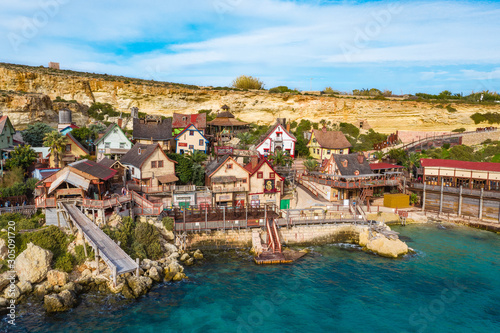 Popeye Village, also known as Sweethaven Village. Sunny day, blue sea, blue sky. Close up view. Mellieha city. Malta island