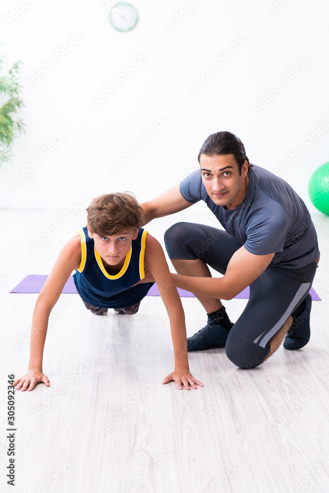 Young father and his son doing exercises Young father and his son doing exercises