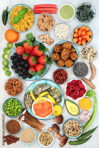 Healthy super food collection with foods high in antioxidants, vitamins, minerals, protein, smart carbs, omega 3 and fibre.  Good health concept. Flat lay, top view.