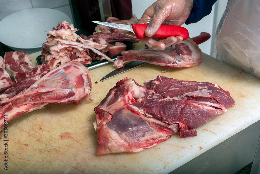 Ukraine, meat workshop, butcher cutting meat